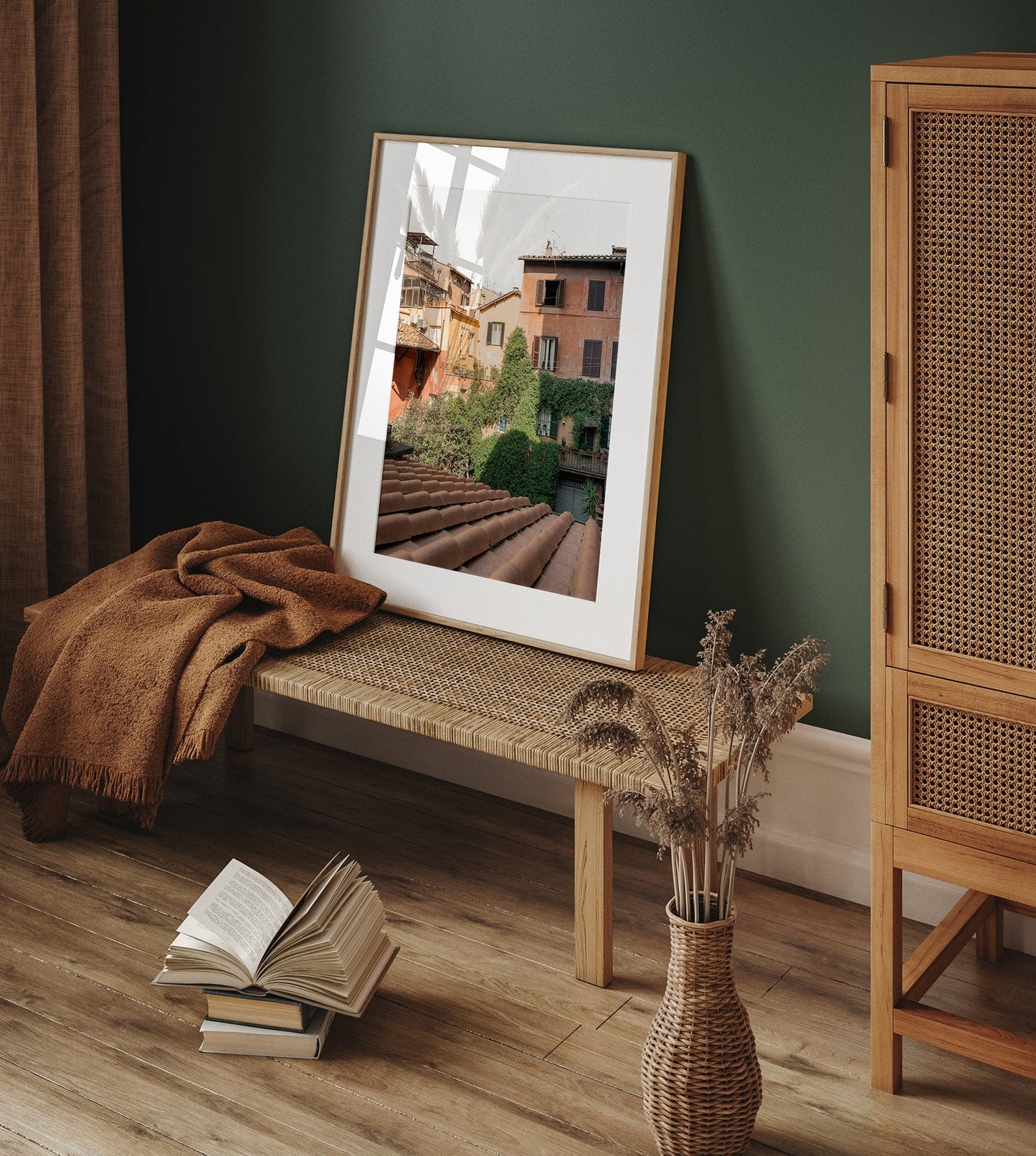 Woke Up in Rome photo on a wicker bench with a brown blanket, open book, and dried flowers in a vase nearby.
