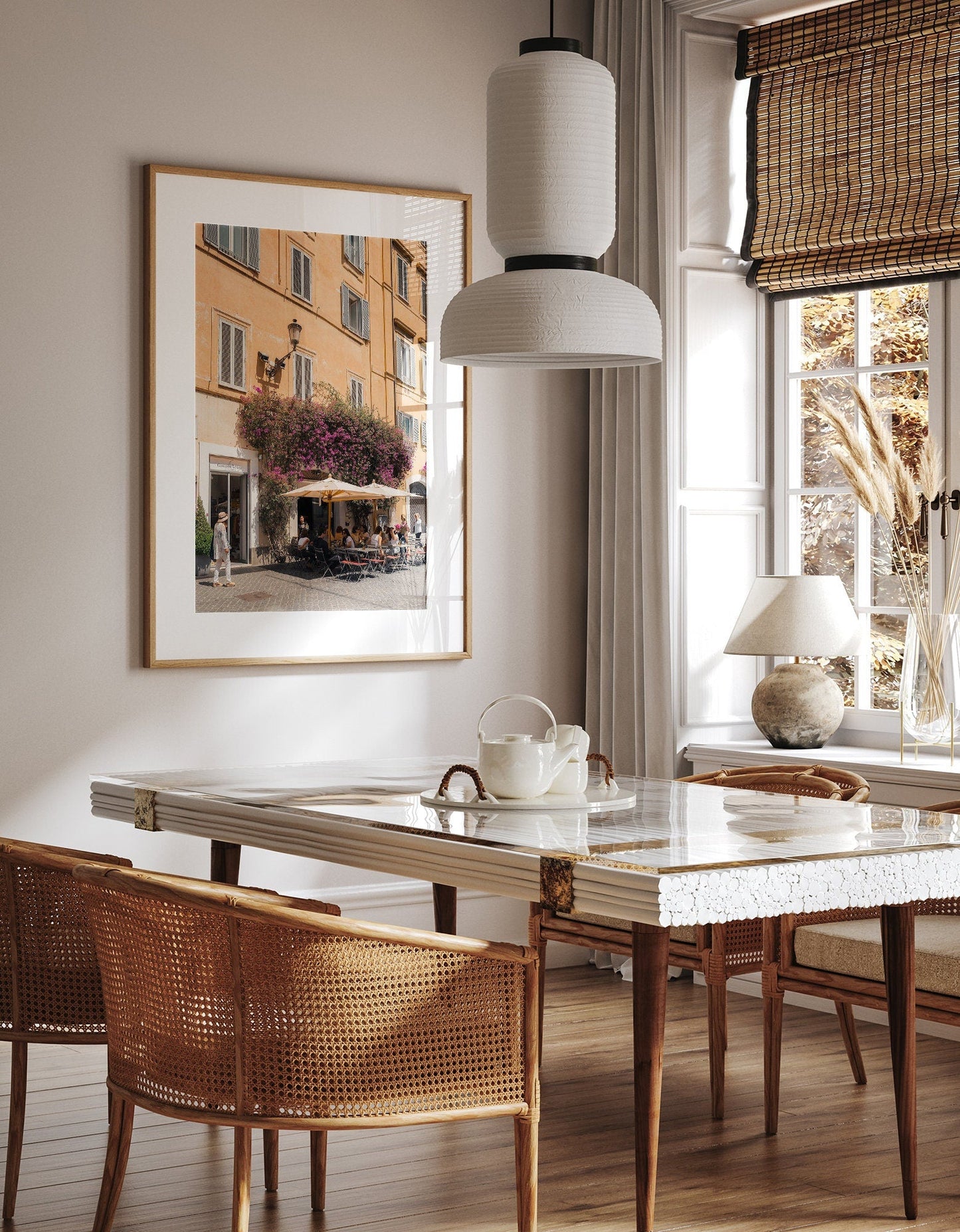 A cozy dining room with the Yellow Charm marble table, wicker chairs, art, pendant light & sunlight streaming through windows.