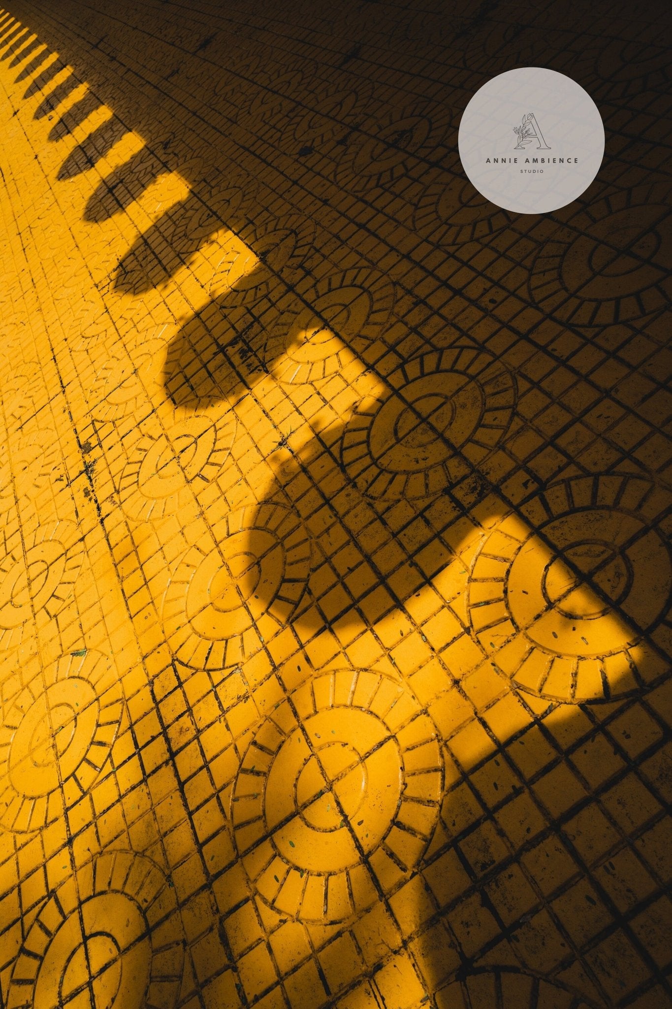 Shadow of a person with a hat on the Yellow Harmony surface under warm sunlight.