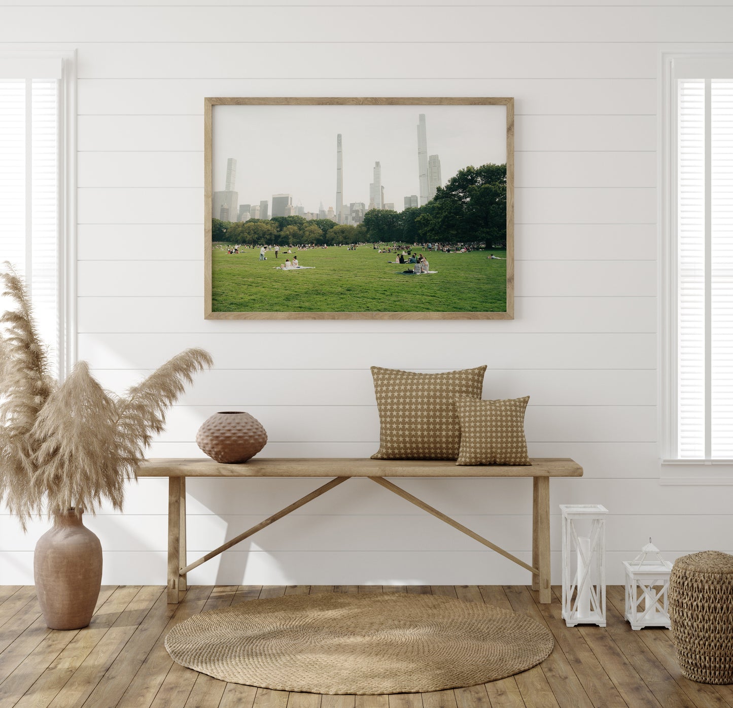 Neutral-toned room with a wooden bench, woven decor, and the "Great Lawn" wall art depicting skyscrapers in a city park.