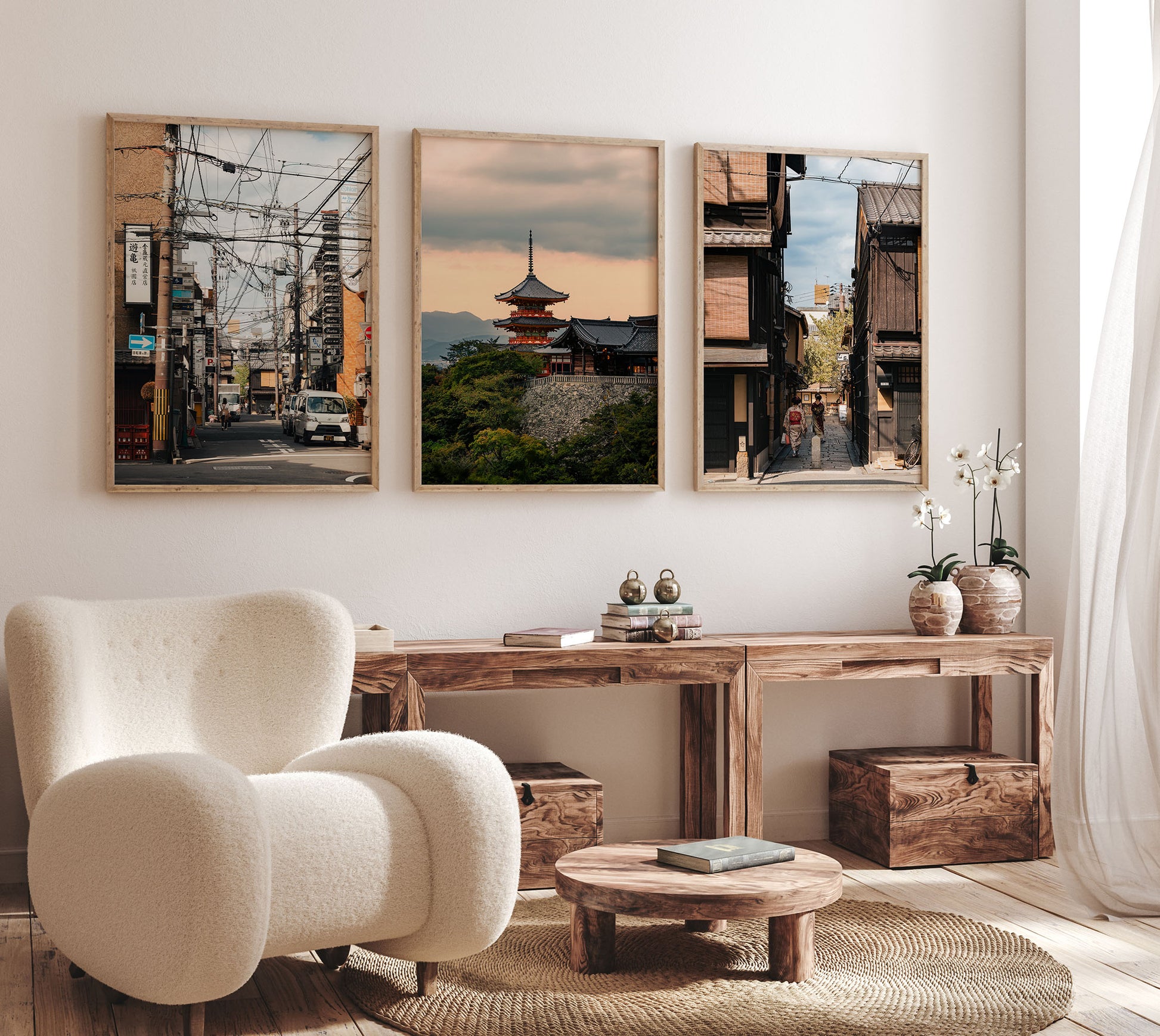 A cozy living room with a plush chair and Kyoto Allure - Set of 3 cityscape photos above a wooden console table.