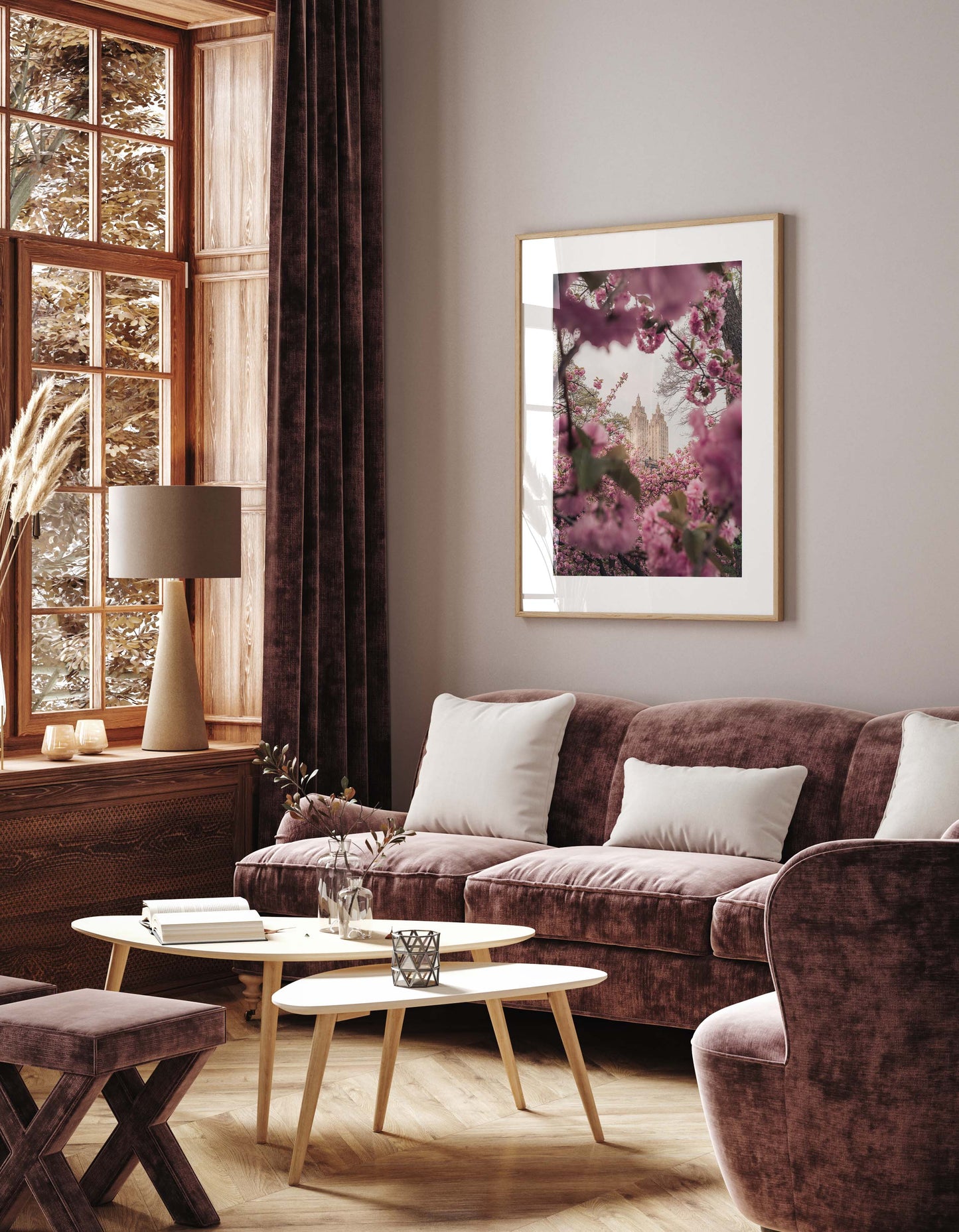 Elegant living room with mauve velvet sofa, light wood tables, large window, and Cherry Blossom II artwork on the wall.