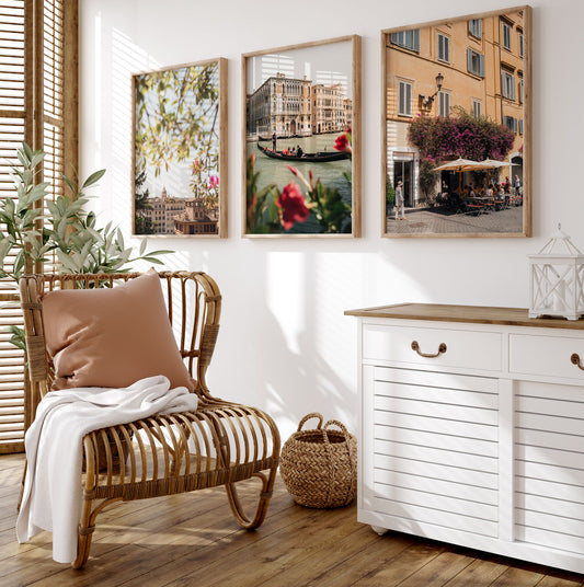 Cozy room with wicker chair, white blanket, sideboard, plant, and Bright Day in Italy - Set of 3 on the wall.