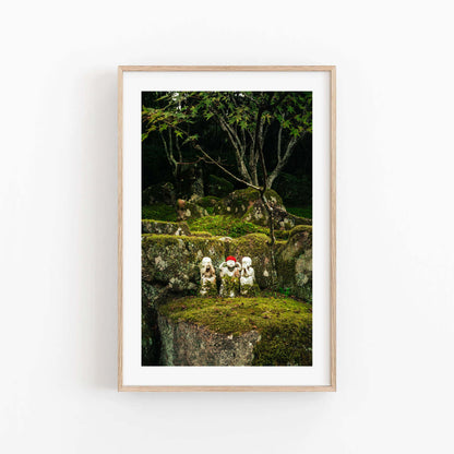 Framed Three Wise Ones photo of statues on mossy rocks surrounded by forest trees.