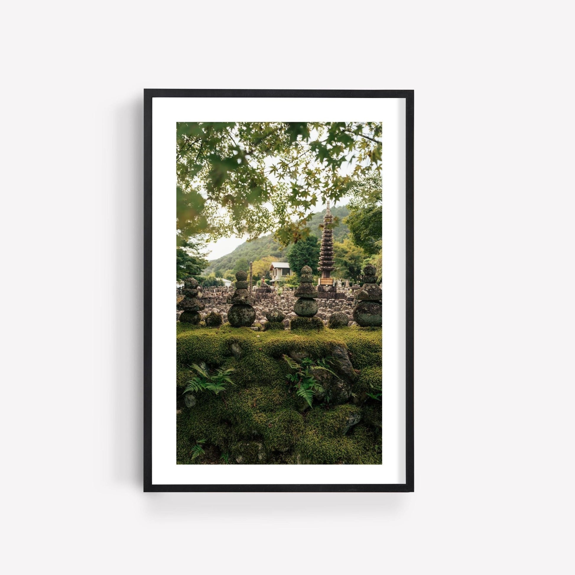 Framed photo titled Adashino Nenbutsu-ji, featuring a serene garden with a stone pagoda and lush greenery beneath a canopy of trees.