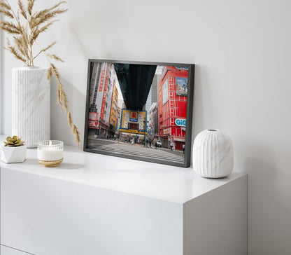 The framed Akihabara photo sits on a white cabinet, accented with vases and a candle.