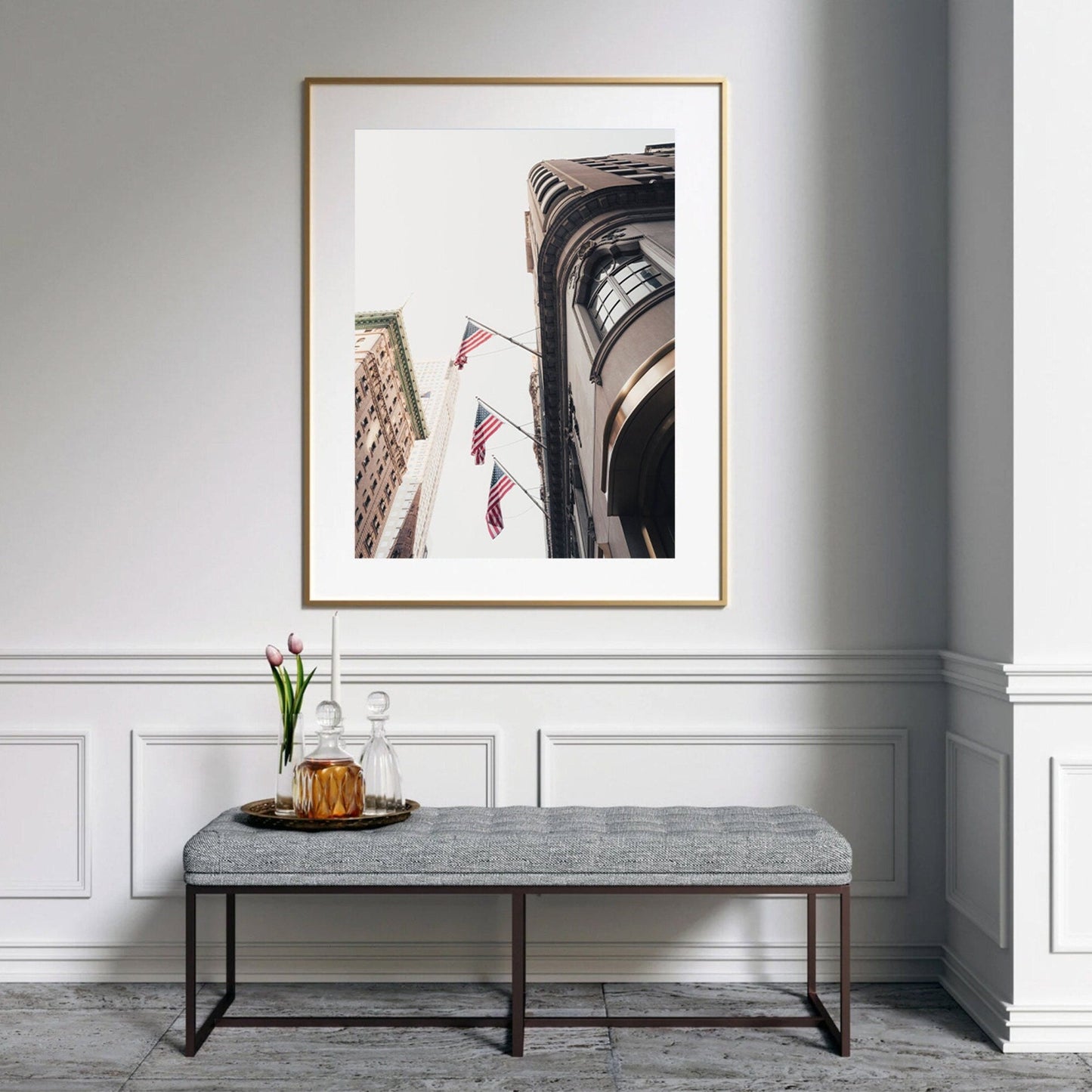 American Pride photo of buildings with flags, above bench and decorative tray with flowers and glassware.