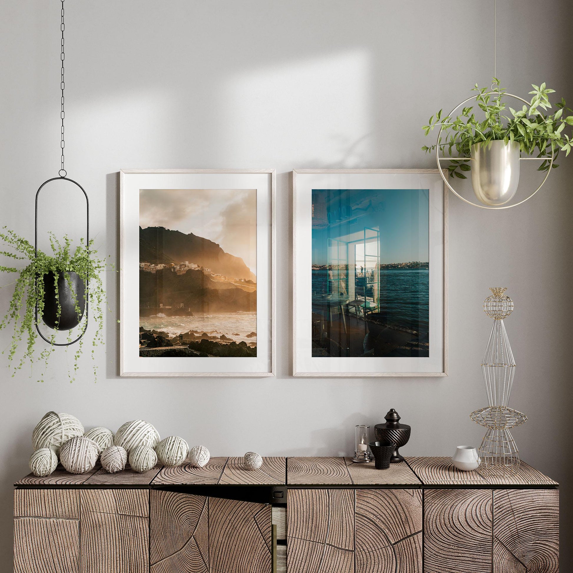 Minimalist room with Atmospheric Coasts - Set of 2 framed photos, plants, and decor on a wooden cabinet.