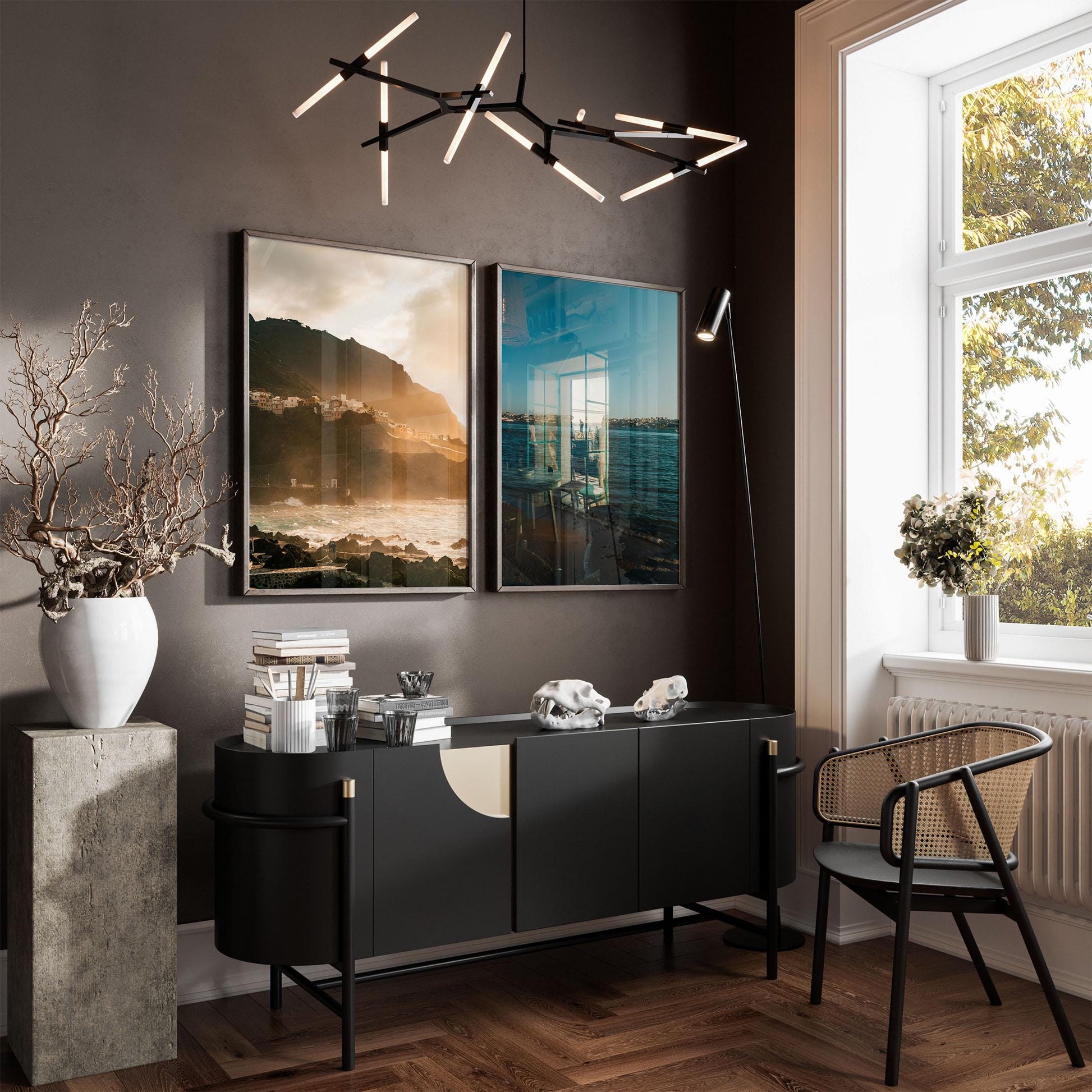 Modern living room with black sideboard, chair, vase with dried branches, sunlight, and Atmospheric Coasts - Set of 2 art.