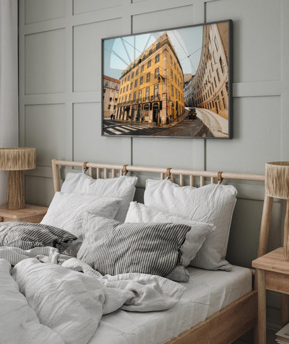 Cozy bedroom with the Baixa-Chiado wooden bed, gray bedding, and a framed cityscape above the paneled wall.