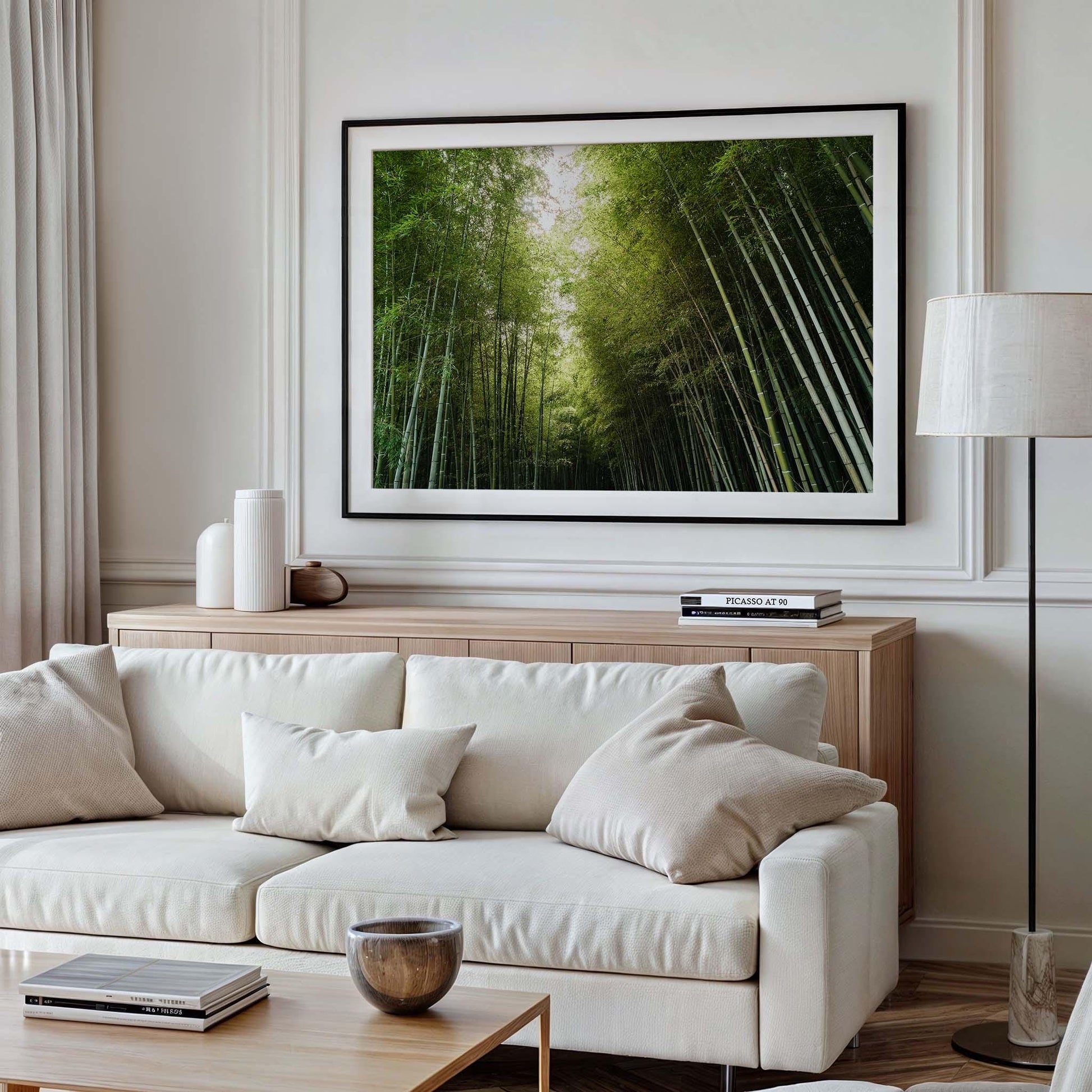 A stylish, mordern living room featuring a white sofa and wooden coffee table is enhanced by a large Bamboo Forest I photography print on the wall.