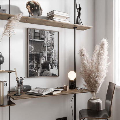 Minimalist home office with shelves, desk, lamp, decor, and a Bayard St. Black and White cityscape photo.