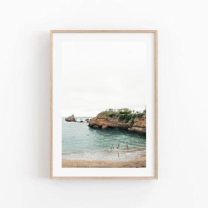 Biarritz Beach II: A framed beach scene with cliffs, ocean, and swimmers near the shore.