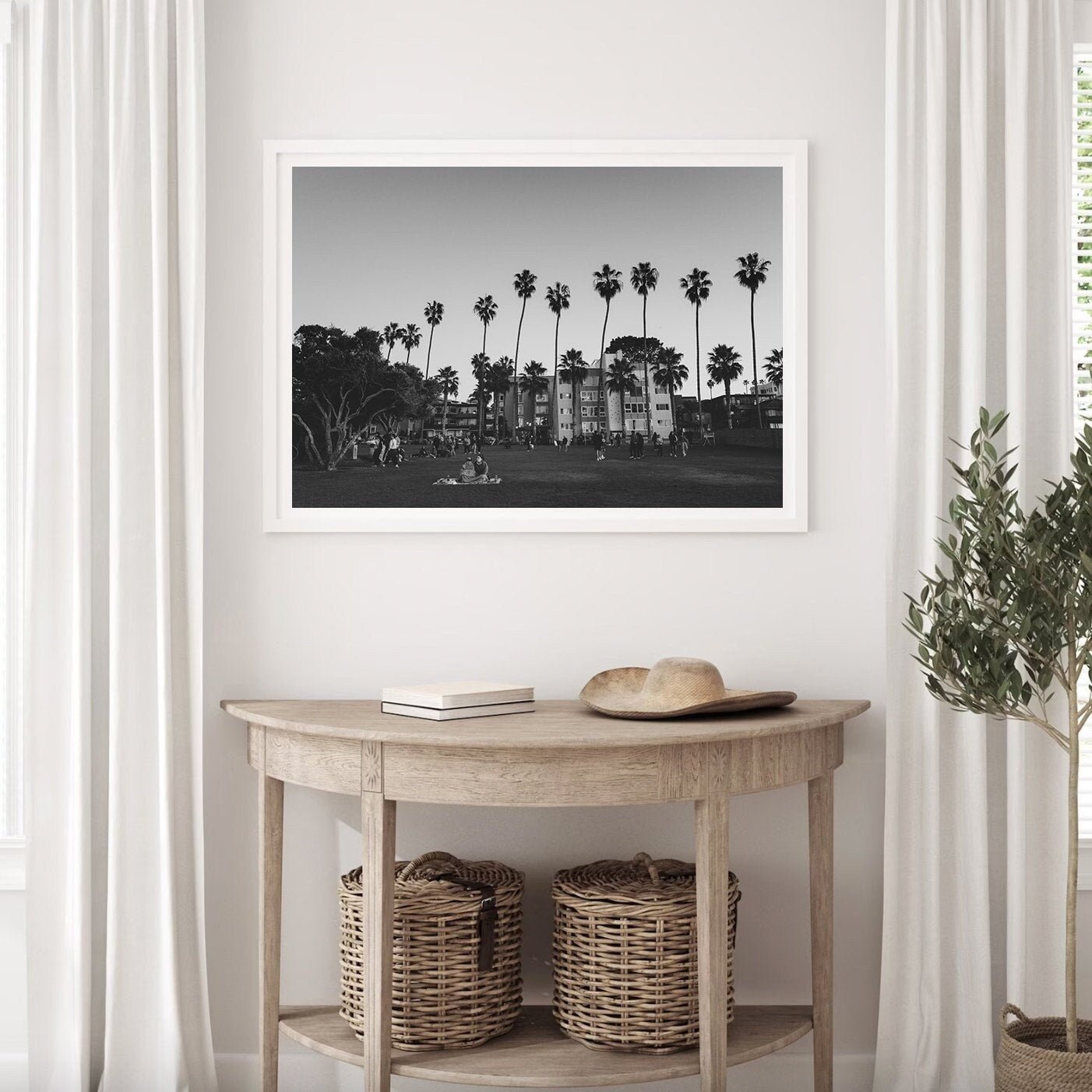 California Evening Black and White photo of palm trees and buildings on a light wall above a wooden table with baskets.