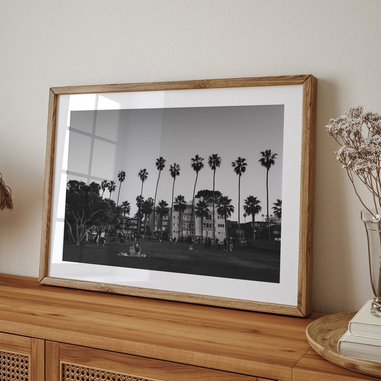 The California Evening Black and White photo on a wooden table with dried flowers in a vase.