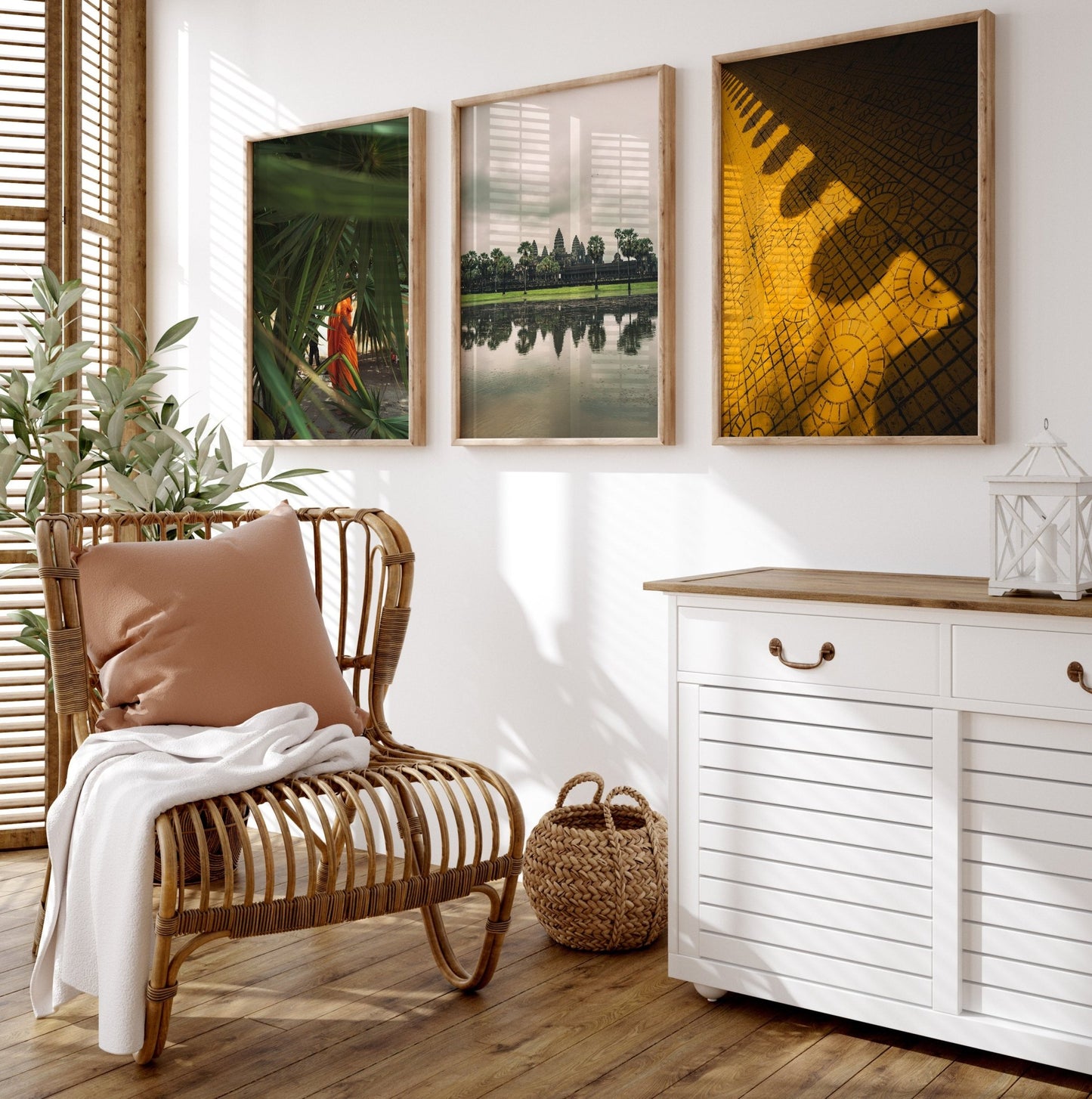 Cozy room with a rattan chair, plants, and a cabinet. Cambodian Culture - Set of 3 artworks hang on the wall.