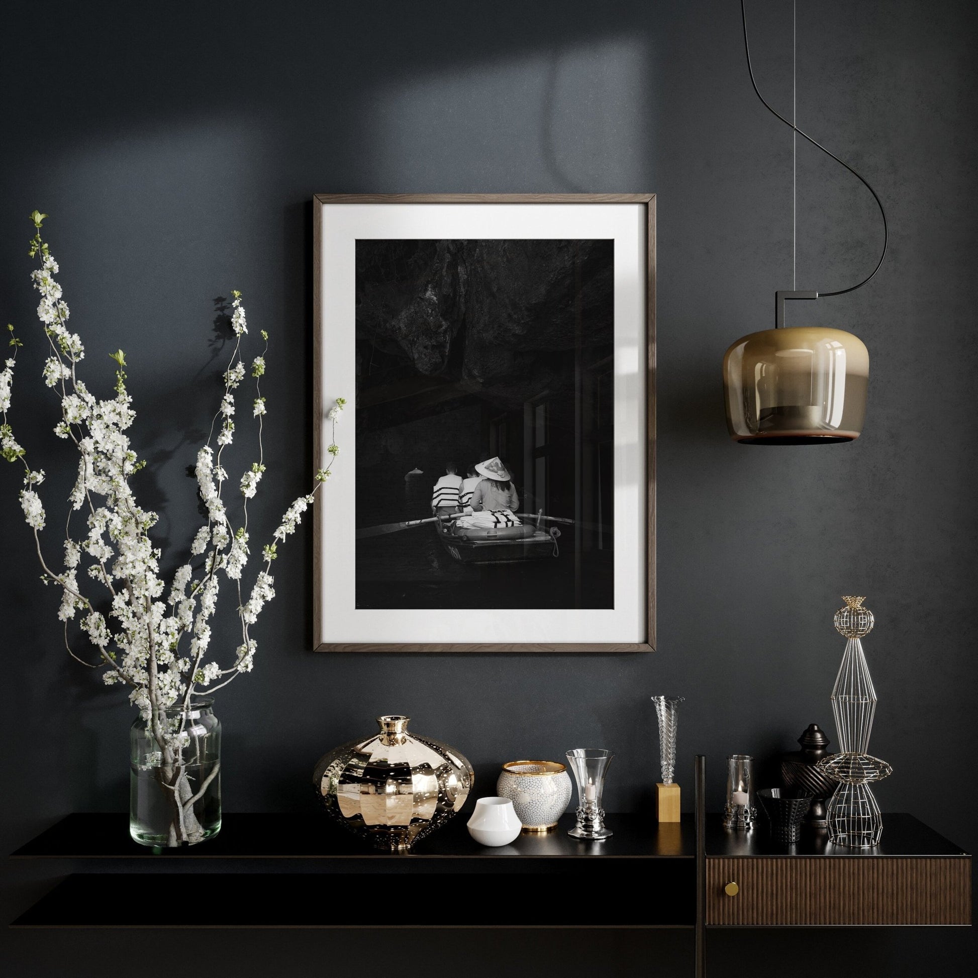 Cave Boat Black and White shelf with art, flower vase, decor, and pendant light against a dark wall.