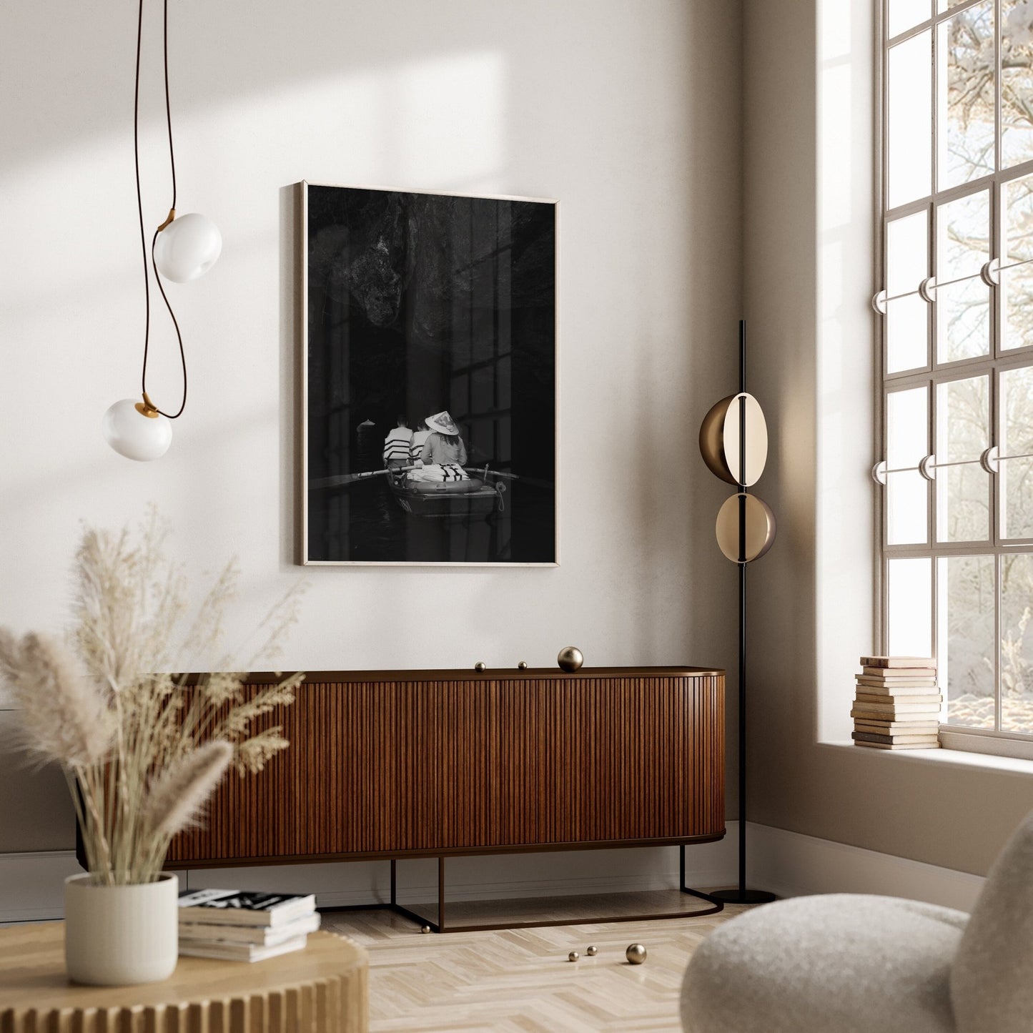 Minimalist living room with large window, Cave Boat Black and White console, abstract wall art, and stylish pendant lights.