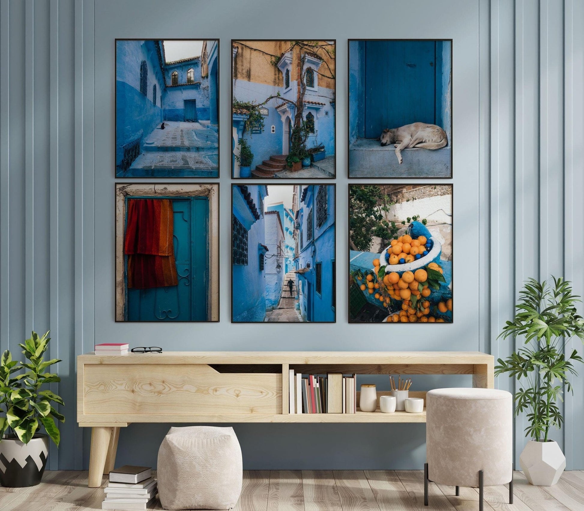 A wall displays the Chefchaouen - Set of 6 above a wooden desk with books and decor.