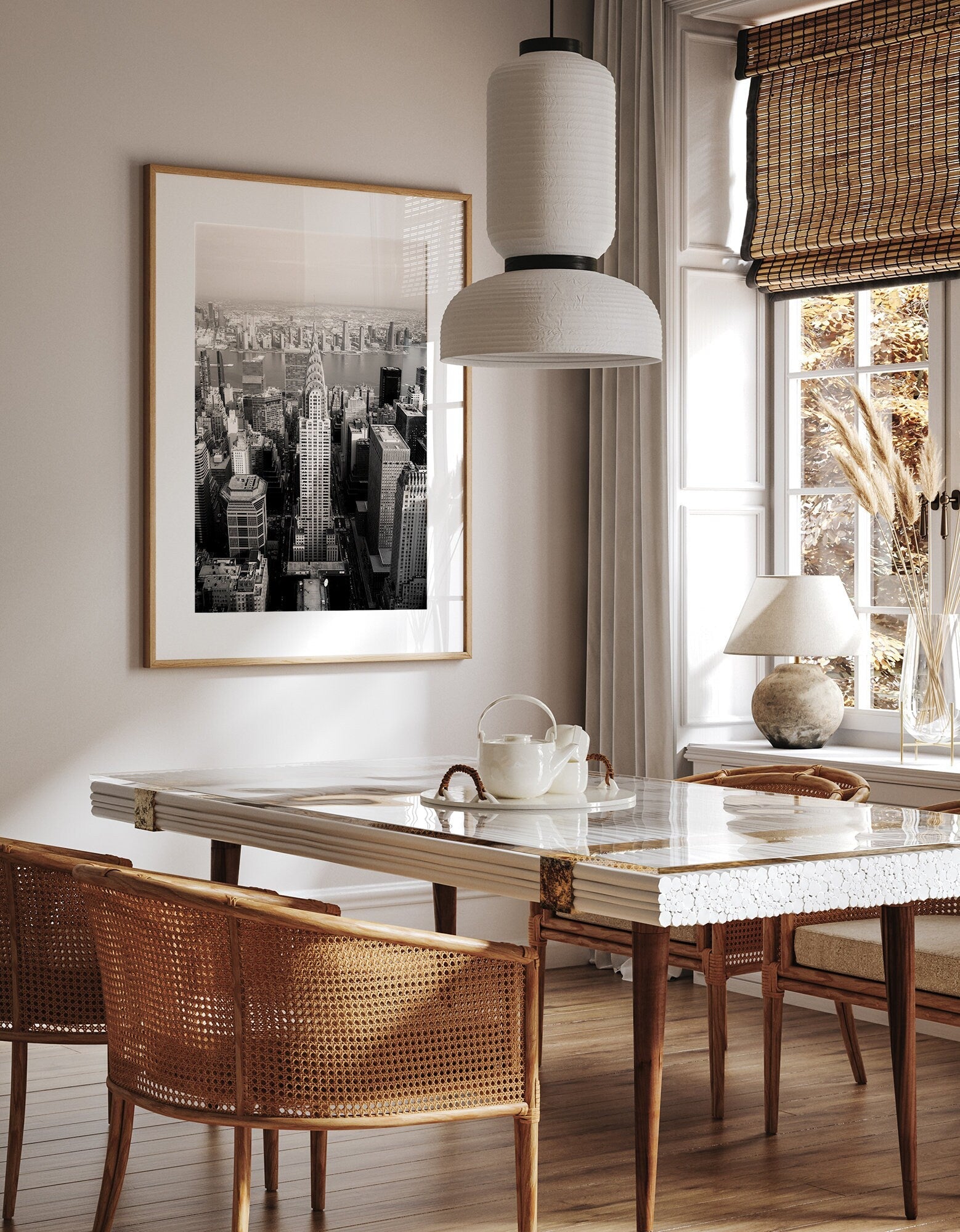 Stylish dining room with a wooden table, wicker chairs, and the Chrysler Building Black and White photo on the wall.