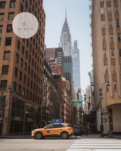 Concrete Jungle: A yellow taxi on a New York street with skyscrapers, including the Chrysler Building, in the background.