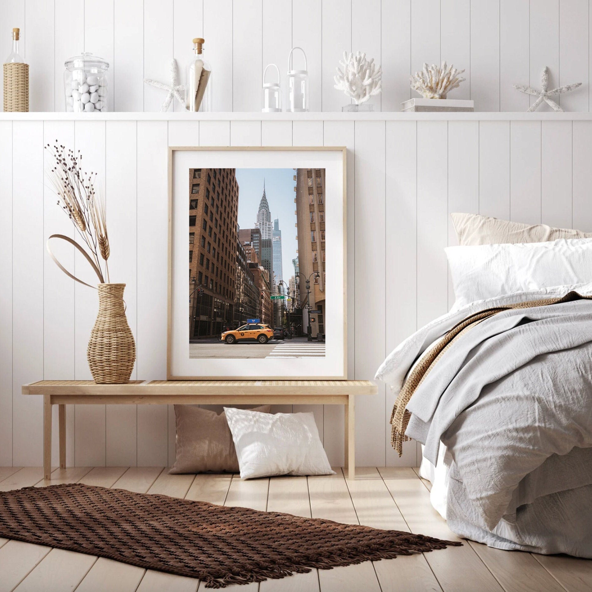 Cozy bedroom with neutral decor, featuring a framed painting called Concrete Jungle and a textured rug on the floor.