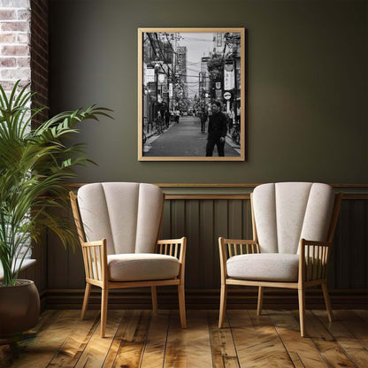 Two armchairs and a potted plant adorn the room, with Echoes of Osaka black-and-white Japanese print on the wall, showcasing timeless interior style.