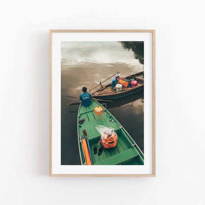 Evening Shift: Two wooden boats on a calm river, one carrying goods, all framed in wood.