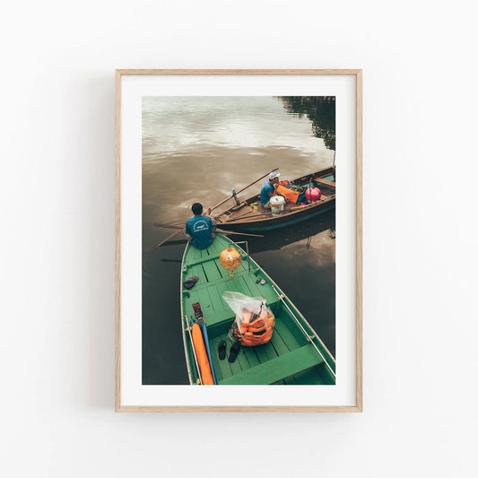 Evening Shift: Two wooden boats on a calm river, one carrying goods, all framed in wood.