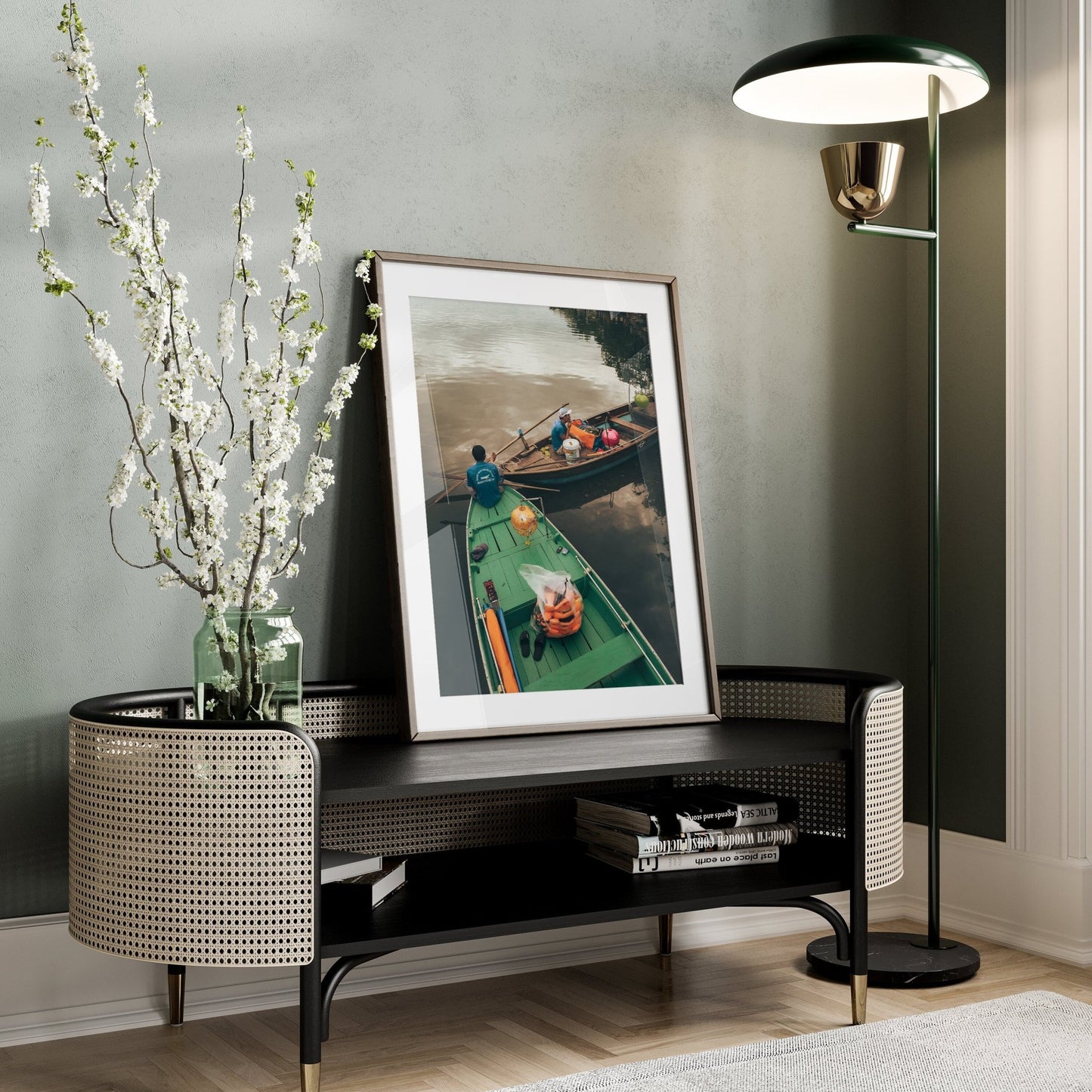 An Evening Shift photo leans on a console table next to flowers in a stylish, minimal living space.