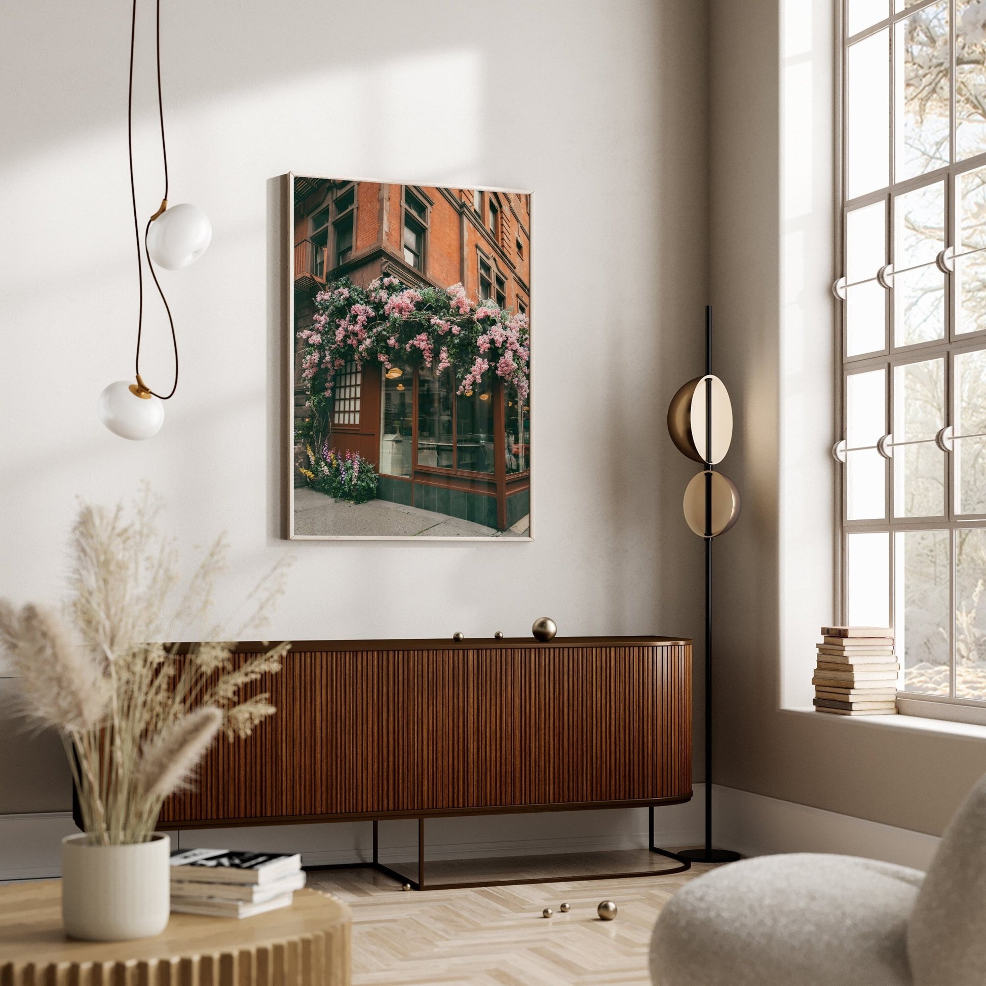 Modern living room with a Floral Cafe painting, natural light, wooden sideboard, and decorative plants.