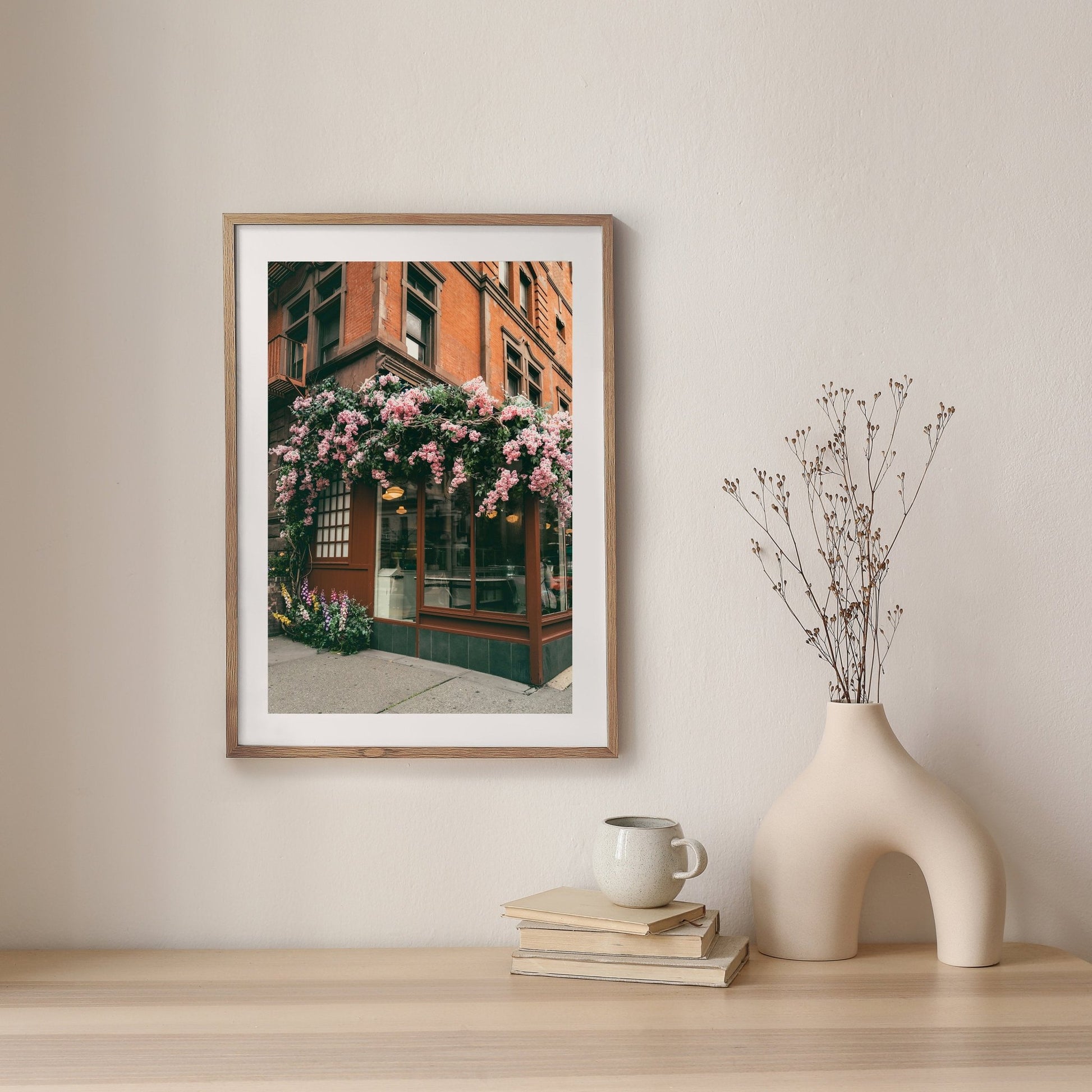 Floral Cafe photo displayed on a minimalist shelf with a vase and mug.