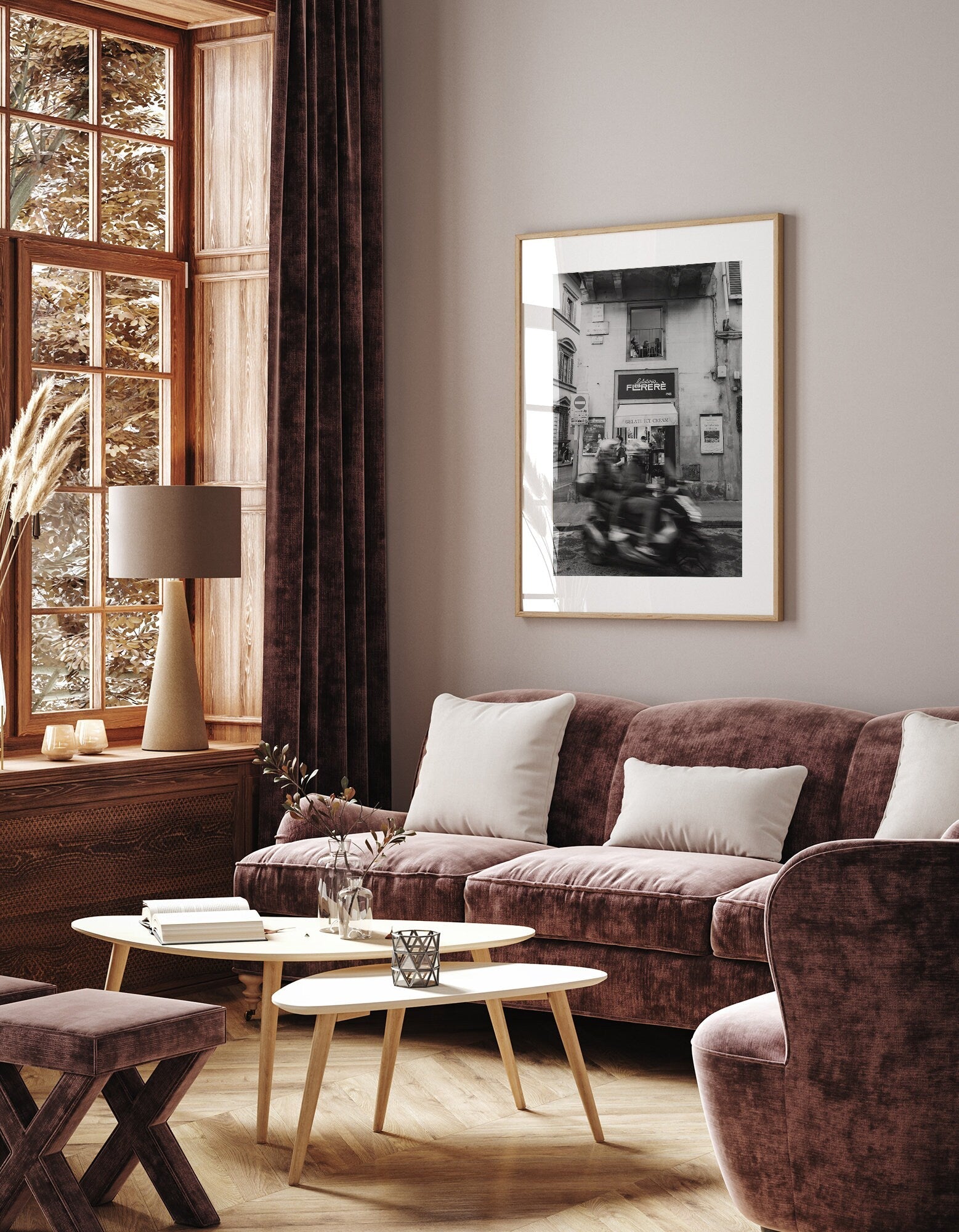 Cozy living room with velvet seating, a wooden coffee table, and a Florence Motorcycle Black and White photo on the wall.