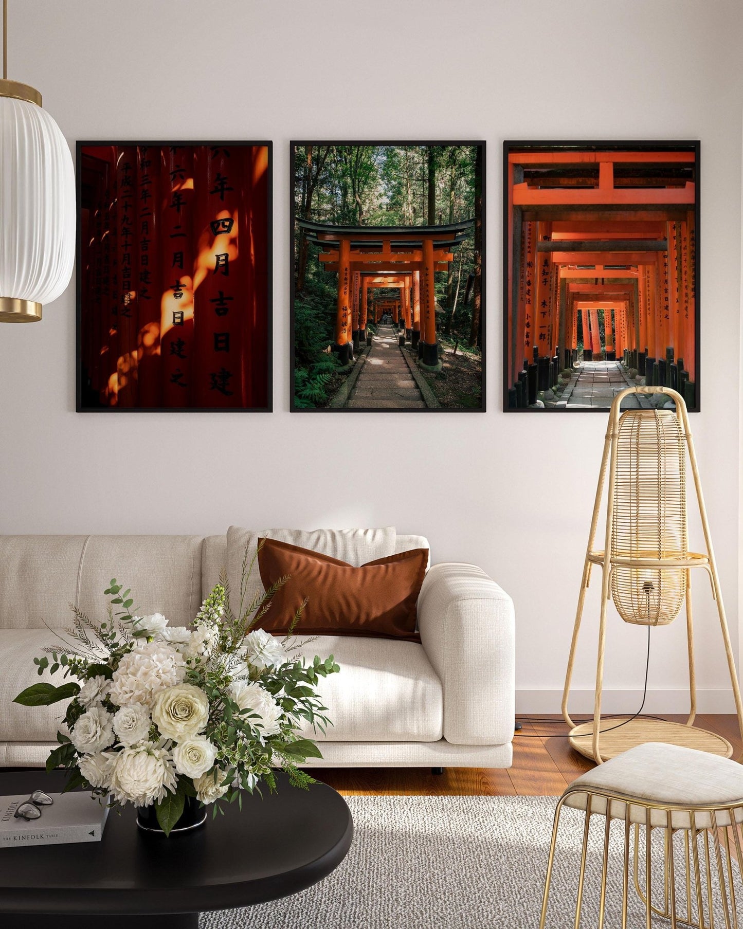 Living room showcasing a white sofa, a floral arrangement, and the Fushimi Inari Taisha Set of 3 framed photography prints depicting red torii gates with high-resolution detail.