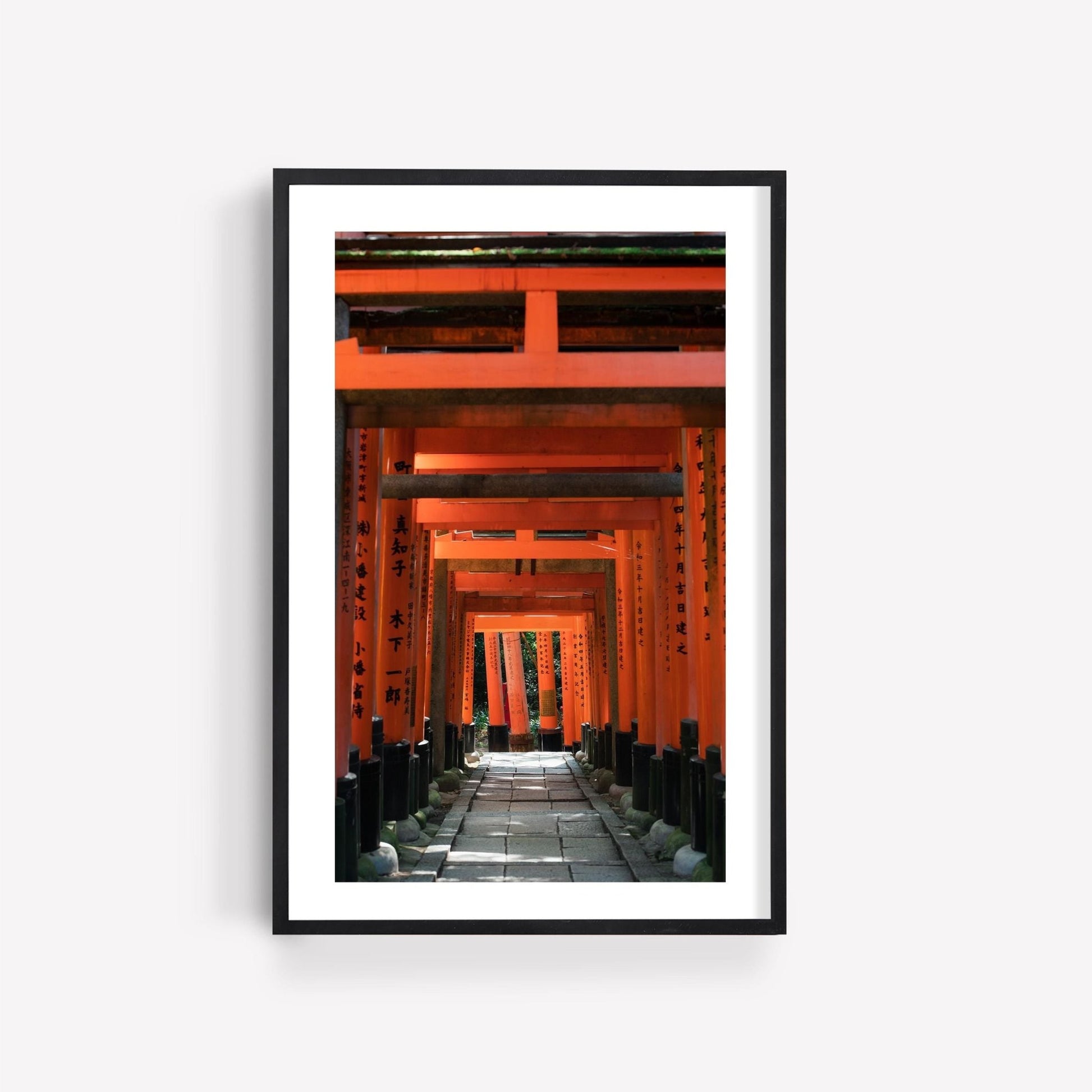 Photography print of Japanese red torii gates at Fushimi Inari Taisha with a black frame.