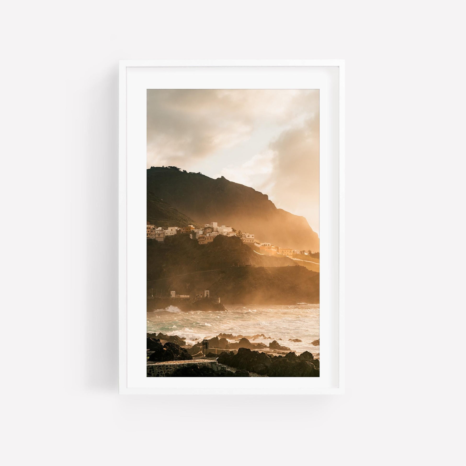 Framed photo Golden Garachico: a coastal village on a rocky hill at sunset, illuminated by golden ocean sunlight.