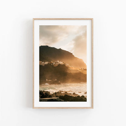Framed photo of Golden Garachico: a coastal village at sunset, with waves below and golden sky above.
