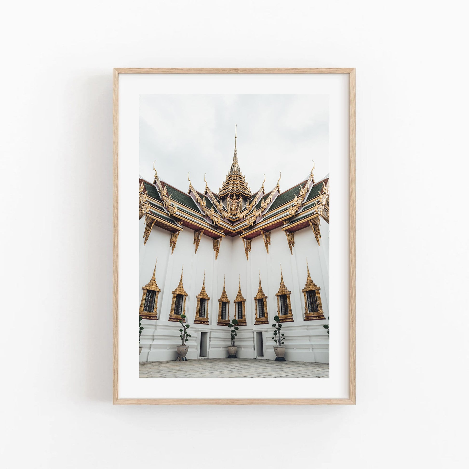 Framed photo titled Grand Palace VI featuring an ornate temple with golden spires against a white background.