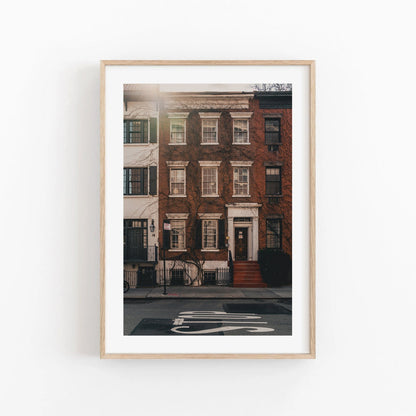 Framed photo called Grove Street, featuring a brick townhouse on a quiet street with a bike lane.