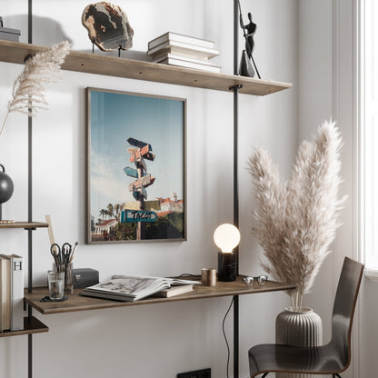 Minimalist workspace with a floating desk, pampas grass, lamp, and the framed Guide the Way picture on the wall.