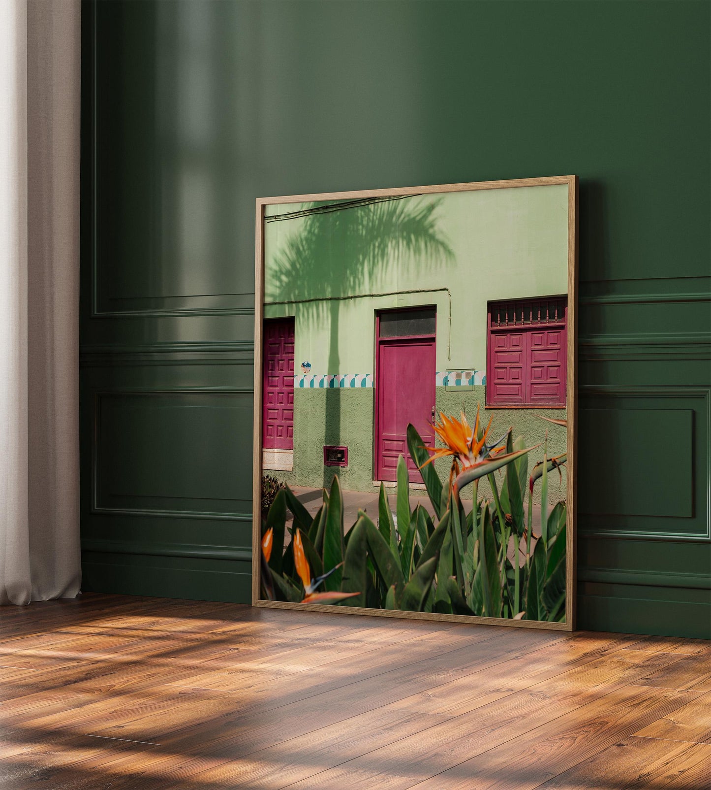 Framed Hot House Paradise photo: colorful building, pink doors, tropical flowers, green wall background.