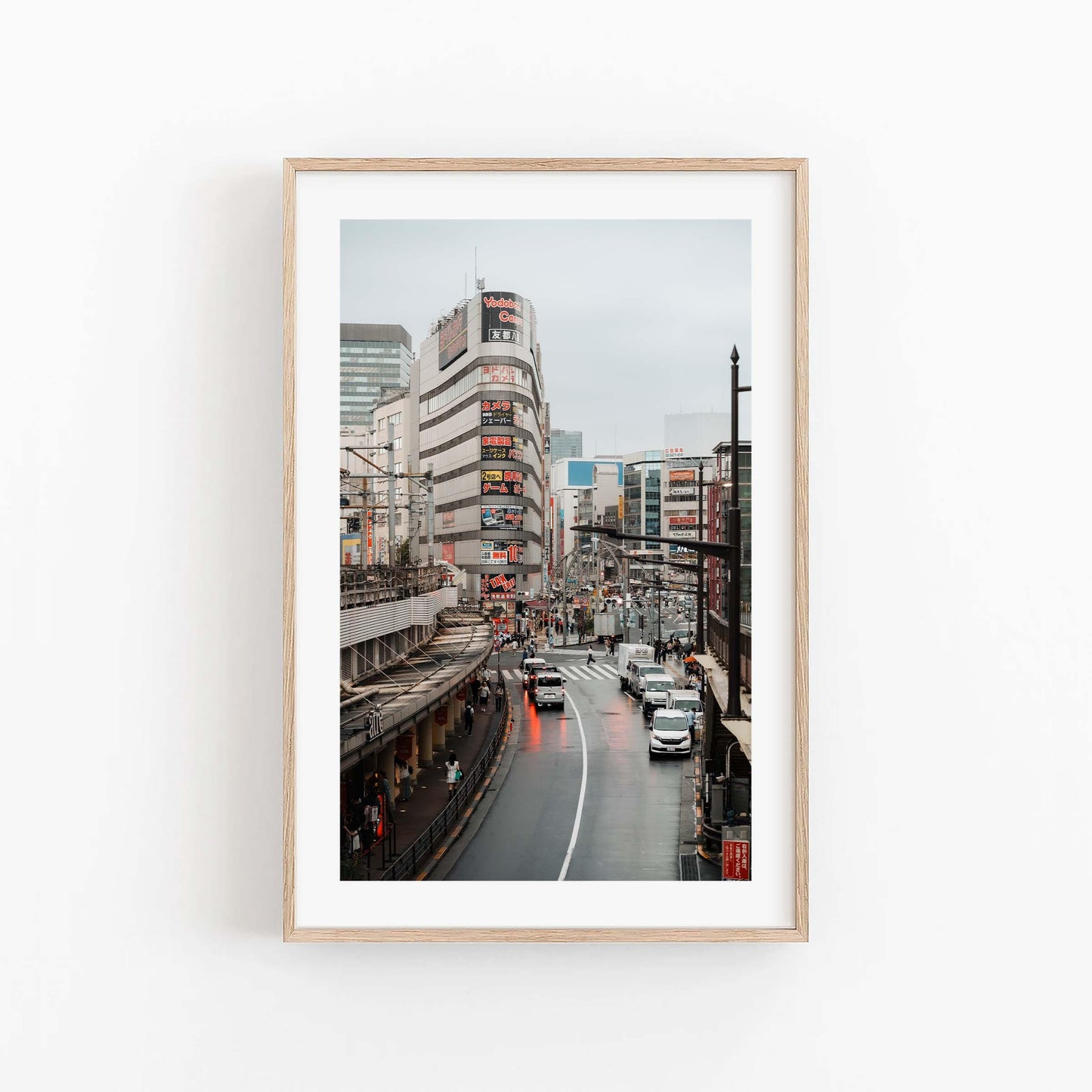 Ueno Cityscape: A framed photo of a busy urban street with cars, pedestrians, tall buildings, and an overcast sky.