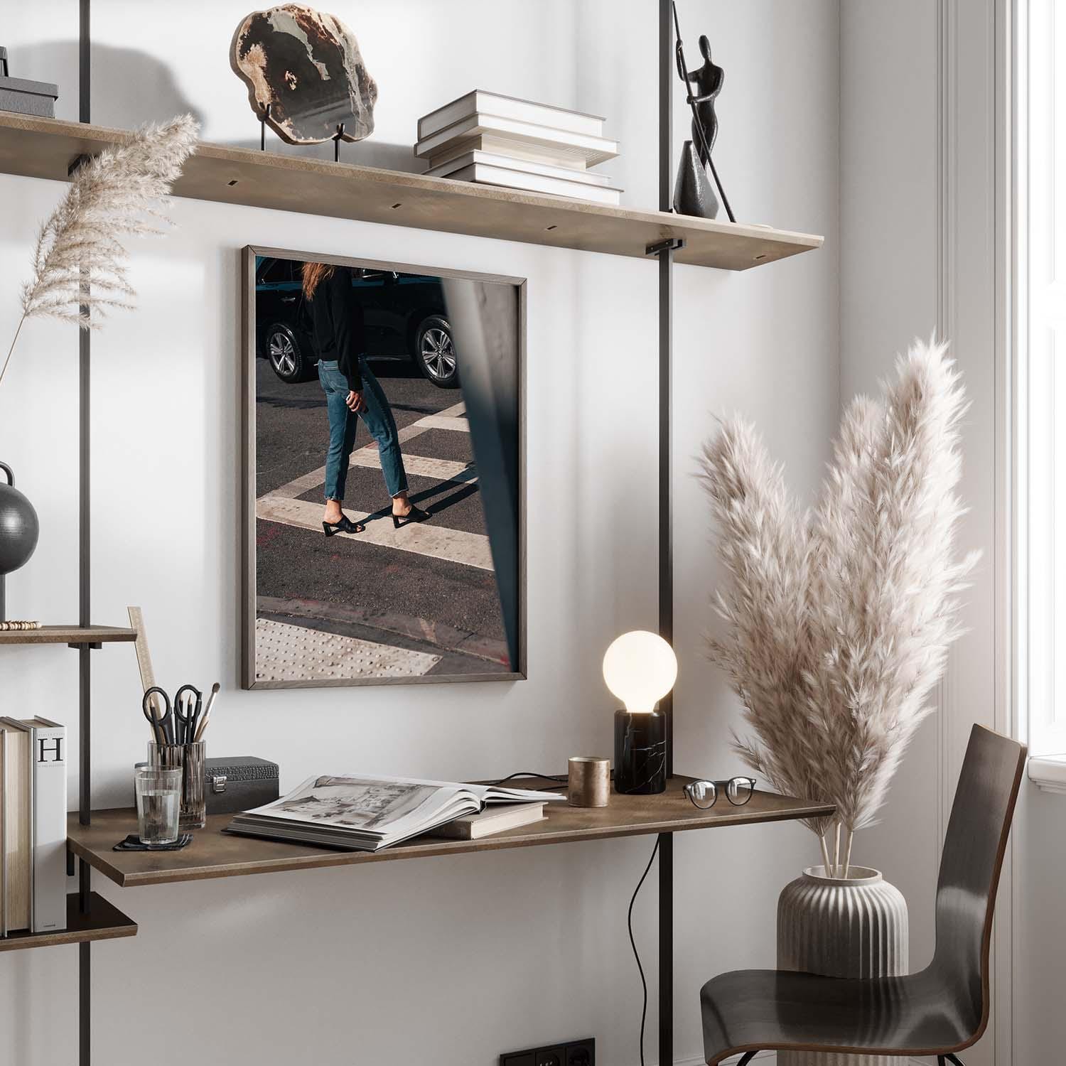 Minimalistic workspace featuring Sunday Chic wooden desk, shelf, table lamp, decorative grass, and street scene photo.