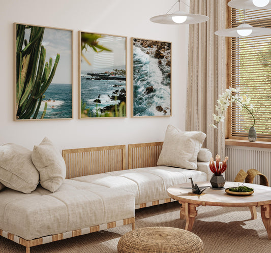 A cozy living room with beige sofas, a wooden table, and the Puerto de la Cruz - Set of 3 on the wall.