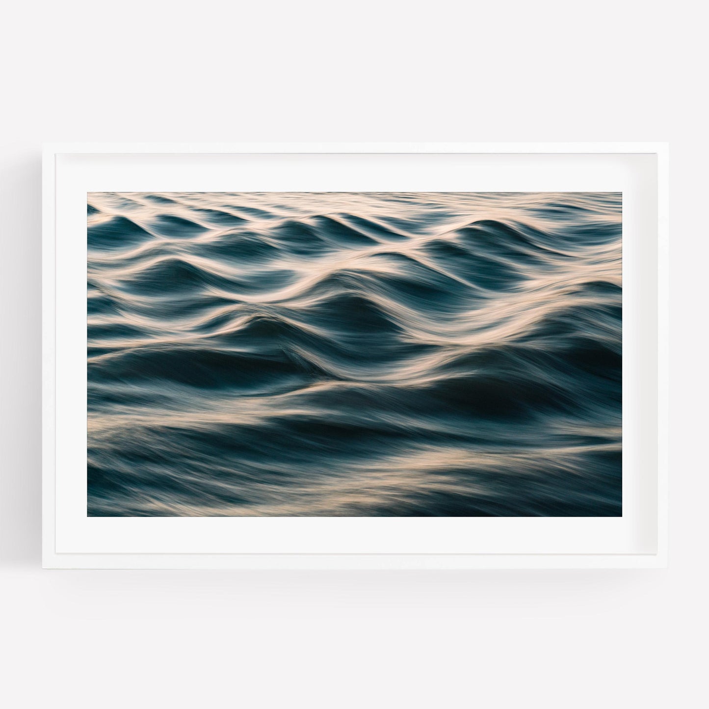 Silk Waves: A framed photo of gentle ocean waves with soft light on a white background.