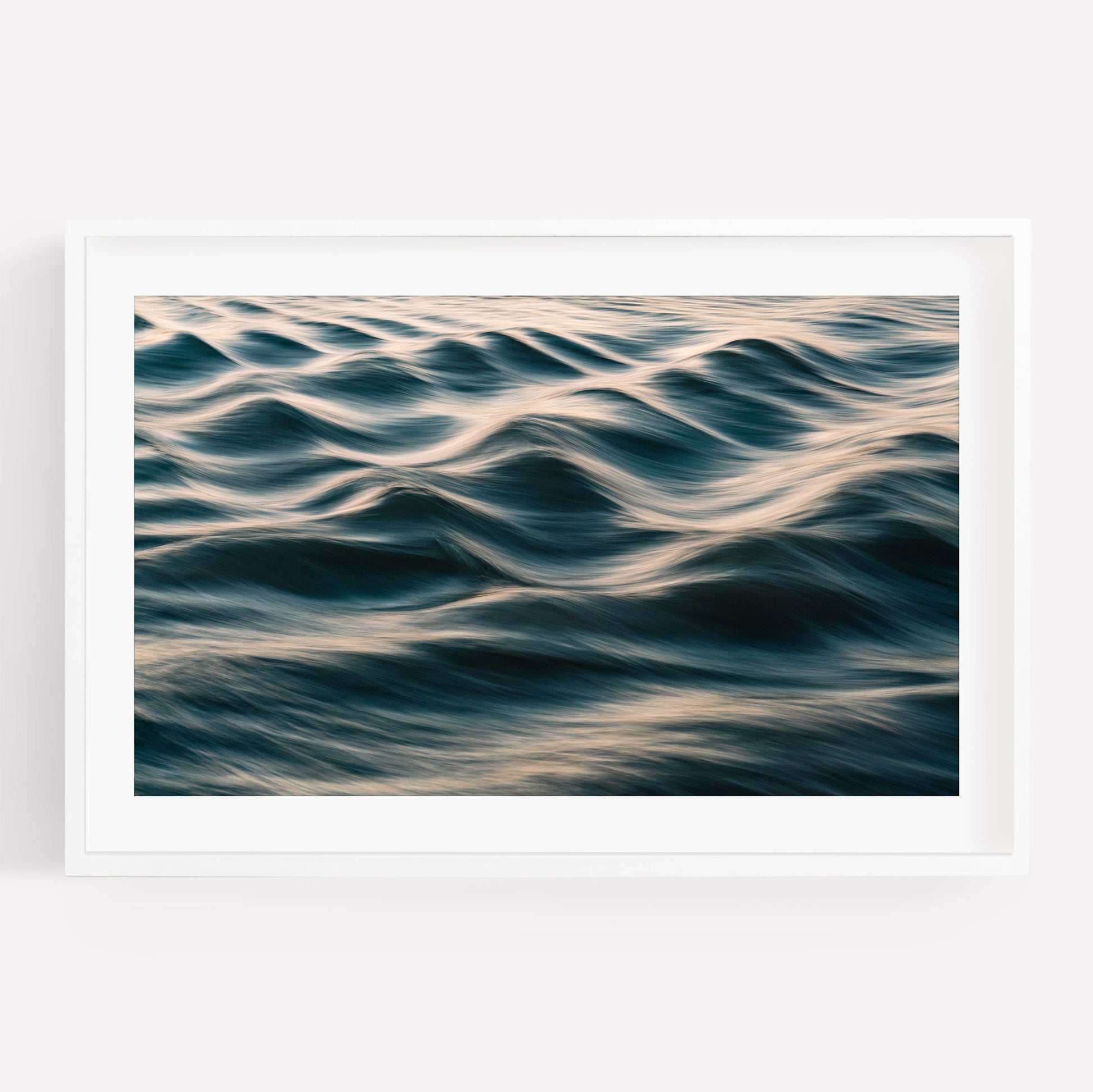 Silk Waves: A framed photo of gentle ocean waves with soft light on a white background.