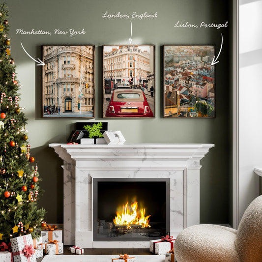 A cozy living room with a lit fireplace, Christmas tree, and The Atlantic Trio - Set of 3 cityscape photos on the wall.