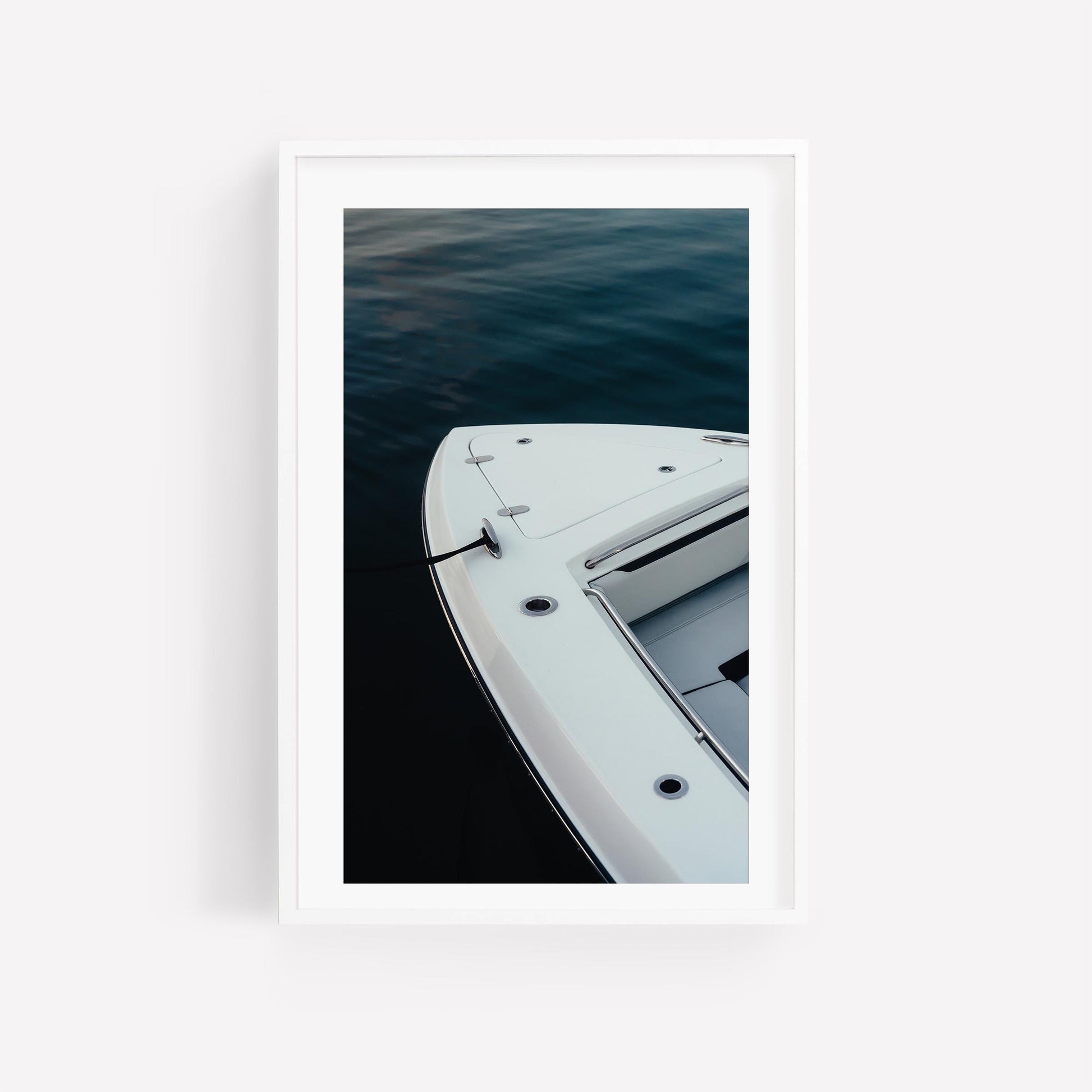 Blue Hour Mooring“ is a minimalistic vertical photo of a white boat docked on calm, dark water.