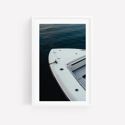 Blue Hour Mooring“ is a minimalistic vertical photo of a white boat docked on calm, dark water.