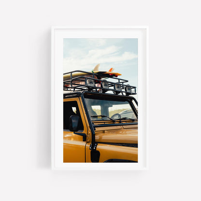 Surf Roadtrip: A yellow SUV with roof rack & surfboard, in a modern white frame against a white background.